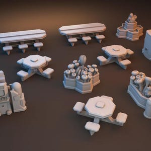 May include: A collection of miniature, light gray, 3D-printed models of park and outdoor elements. The set includes picnic tables, benches, planters, and arcade game machines. The Dragon's Rest logo is visible in the bottom left corner.