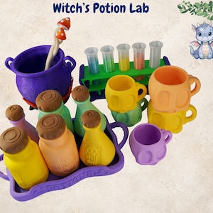 May include: A Witch's Potion Lab set featuring a purple cauldron with a mushroom stirrer, a green test tube rack with five tubes, a purple tray labeled POTIONS, three colored bottles with brown caps, and four skull-shaped mugs in yellow, orange, and purple.