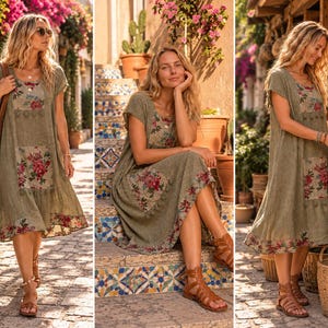 May include: A sage green midi dress featuring short sleeves, a round neckline, and floral patterned panels on the chest, skirt, and hem. The dress includes decorative tassel trim accents along the edges of the floral fabric sections.