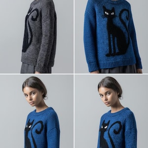 May include: A collection of four images showcasing a knitted sweater with a black cat design. The sweaters are either a dark gray or a vibrant blue. The cat silhouette is prominently displayed on the front of the sweater, with a curled tail and pointed ears. The sweater has a crew neck and long sleeves.
