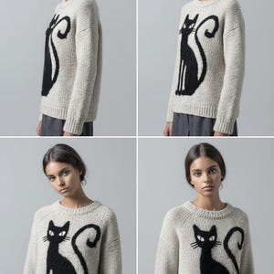 May include: A cream-colored sweater featuring a large black cat design. The cat is depicted in a stylized, seated pose with a curved tail. The sweater has a crew neck and long sleeves, suitable for cooler weather.