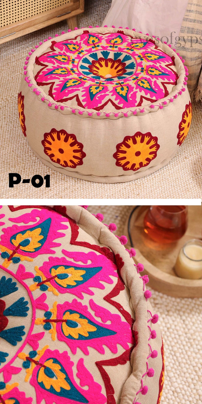 May include: A round, beige, embroidered pouf with pink, yellow, and blue floral designs. The pouf has a fringe border and is decorated with small, white pom-poms.