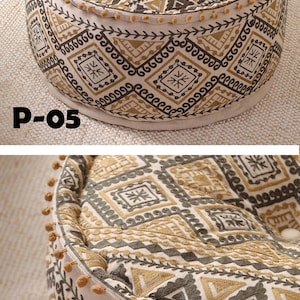 May include: A round, cream-colored pouf with a brown and gold geometric pattern. The pouf has a fringe trim and a label that reads "P-05".