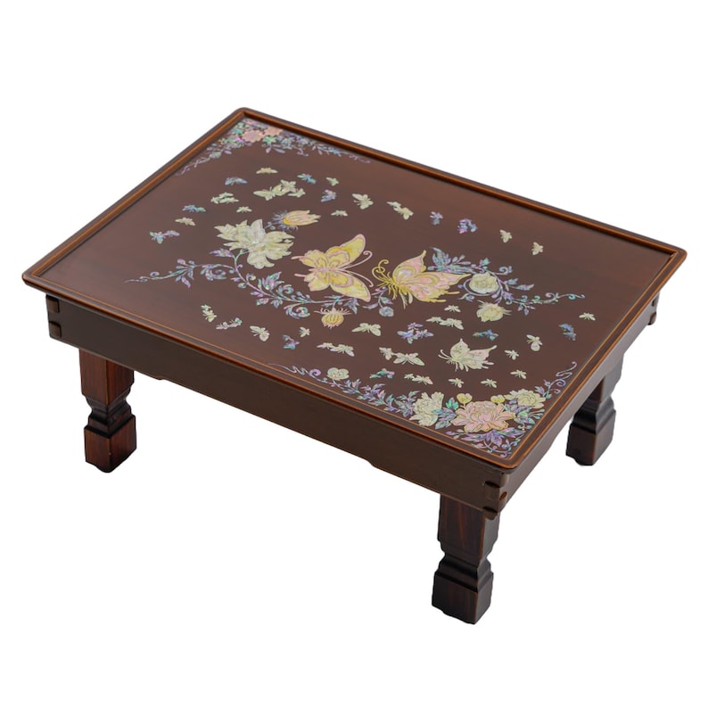 A Brown lacquered table with intricate mother-of-pearl inlay of butterflies and flowers on the surface.
