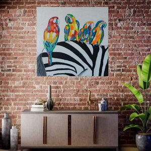 May include: A painting of four colorful parrots perched on a zebra's back. The parrots are a mix of red, yellow, blue, and green. The zebra's stripes are black and white.
