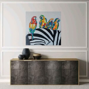 May include: A painting of four colorful parrots perched on a zebra's back. The zebra has black and white stripes. The parrots are a mix of red, yellow, green, and blue.