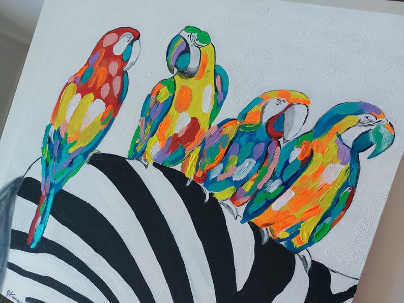 May include: A painting of four colorful parrots perched on a black and white zebra stripe pattern. The parrots are painted in a variety of bright colors, including red, yellow, blue, green, and orange.