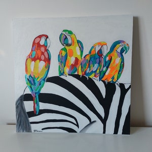 May include: A painting of four colorful parrots perched on a black and white zebra. The parrots are painted in shades of red, yellow, blue, and green.