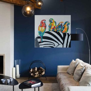 May include: A painting of four colorful parrots perched on a black and white zebra. The parrots are a mix of red, yellow, blue, and green. The zebra is in the background and is facing the left side of the painting.
