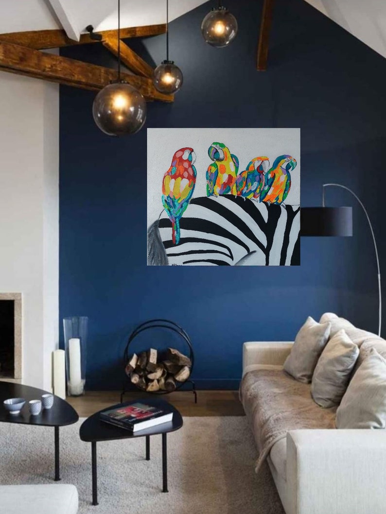 May include: A painting of four colorful parrots perched on a black and white zebra. The parrots are a mix of red, yellow, blue, and green. The zebra is in the background and is facing the left side of the painting.