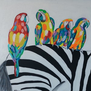 May include: Four colorful parrots perched on a black and white zebra patterned surface. The parrots are painted in shades of red, yellow, blue, green, and orange.
