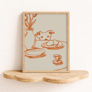 Minimalist terracotta line art poster featuring a curious dog peeking over a kitchen table. The still life scene includes a vase with flowers, plates, and a small coffee cup on a beige background. This modern hand-drawn illustration captures a cozy home or cafe vibe. Perfect as a gift for dog lovers, this aesthetic pet-themed wall decor fits boho and neutral interiors. High-quality physical print for kitchen, dining room, or living room wall art.