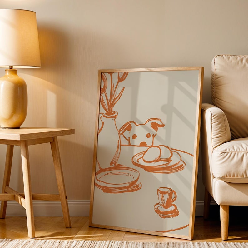 Minimalist terracotta line art poster featuring a curious dog peeking over a kitchen table. The still life scene includes a vase with flowers, plates, and a small coffee cup on a beige background. This modern hand-drawn illustration captures a cozy home or cafe vibe. Perfect as a gift for dog lovers, this aesthetic pet-themed wall decor fits boho and neutral interiors. High-quality physical print for kitchen, dining room, or living room wall art.