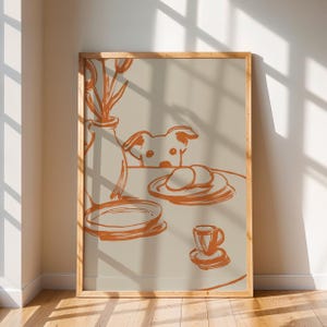 Minimalist terracotta line art poster featuring a curious dog peeking over a kitchen table. The still life scene includes a vase with flowers, plates, and a small coffee cup on a beige background. This modern hand-drawn illustration captures a cozy home or cafe vibe. Perfect as a gift for dog lovers, this aesthetic pet-themed wall decor fits boho and neutral interiors. High-quality physical print for kitchen, dining room, or living room wall art.
