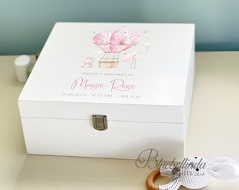May include: A white wooden keepsake box with a pink hot air balloon design and the name "Maisie Rose". The box includes the text "Precious Memories Of" and the date and time of birth, and the baby's weight.