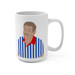 May include: White ceramic coffee mug with a blue and white striped referee shirt design. The person in the shirt has a mustache and is smiling.