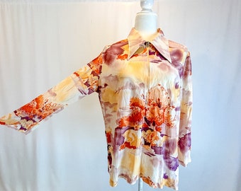 May include: A long-sleeved shirt with a zipper closure and a colorful abstract print featuring shades of orange, purple, and brown on a cream background.