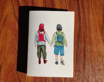 May include: Watercolor painting of two people wearing backpacks and hats walking side by side. The person on the left is wearing a red hat and the person on the right is wearing a blue hat.