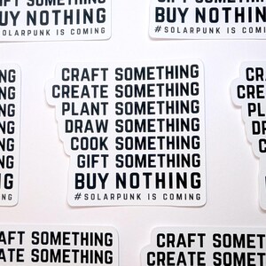 May include: A white sticker with black text that reads "Craft something, Create something, Plant something, Draw something, Cook something, Gift something, Buy nothing #Solarpunk is coming".