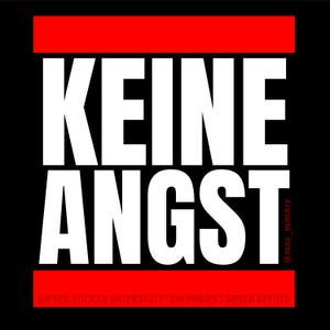 May include: A square sticker with a black background featuring the white text KEINE ANGST in a bold sans-serif font. A horizontal red bar appears at the top and bottom. The bottom bar contains small text reading DIESER STICKER UNTERSTÜTZT EIN PROJEKT GEGEN RECHTS.