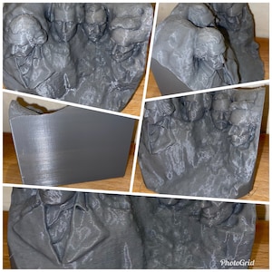 May include: A 3D printed model of a group of people's heads. The model is made of a gray material and has a textured surface. The model is a realistic representation of human heads.