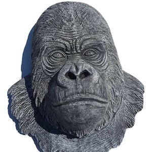 May include: A black and white gorilla head sculpture with a textured surface. The sculpture is made of a hard material and has a realistic appearance.