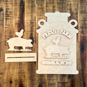 May include: Unfinished wooden cutout of a milk jug with a pig and a chicken on top. The jug has the words "Fresh Farm Organics" on it.