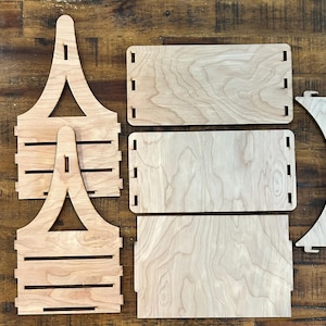 May include: A set of unfinished wooden pieces for building a shelf unit. The pieces are made of light wood with a natural grain. The set includes two side pieces, two shelves, and a back piece.