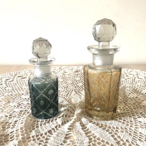 Pair of good sized vintage Czech Bohemian iridescent cut Crystal perfume bottles green and yellow geometric pattern