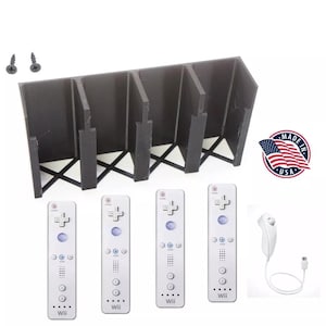 May include: A black plastic controller holder with four slots, four white Wii remotes, and a white Wii remote with a cord. The image also includes two screws and a "Made in USA" sticker.