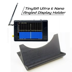 May include: A black TinySA Ultra & Nano Angled Display Holder with a black display device showing a blue and white graphic. The display device has a silver antenna and yellow accents. The text "TinySA Ultra & Nano Angled Display Holder" is above the device.