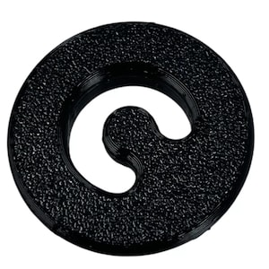 May include: A black, circular object with a textured surface and a curved, open center. The object appears to be made of a solid material and is set against a plain white background. The design is simple and modern.