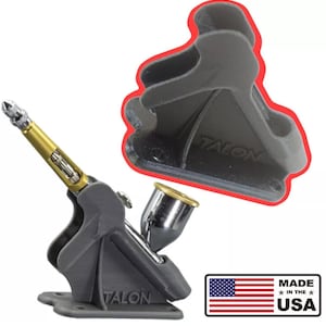 May include: A grey airbrush with gold detailing and the word "TALON" printed on the base. A separate grey holder is also shown. The image includes a "MADE IN THE USA" graphic.