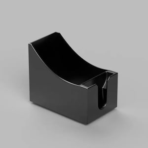 May include: A glossy black desk organizer with a curved top and a slot for holding items. The rectangular base has a small cutout on the front. The organizer is made of a solid, opaque material.