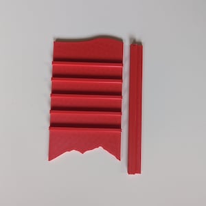 May include: A red plastic shelf unit with five shelves and a separate red plastic vertical piece.