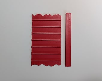 May include: Two red plastic pieces, one with a wavy edge and multiple horizontal lines, the other a straight piece.