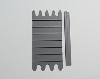 May include: A grey 3D printed plastic mould with a series of ridges and a wavy edge. A separate grey 3D printed plastic strip is also included.