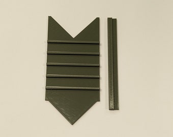 May include: A green plastic 3D printed object with a pointed top and six slots. The object is designed to hold small items, such as cards or paper. A separate green plastic 3D printed piece is also included.