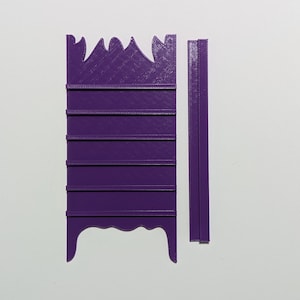 May include: Purple 3D printed shelf unit with 6 shelves and a decorative top. The shelf unit is made of plastic and is designed to be assembled. The shelf unit is shown next to a separate piece that is likely a side panel.
