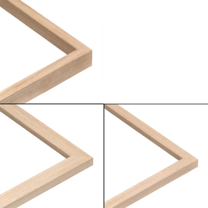 May include: A close-up of a light-coloured wooden picture frame. The frame is rectangular with a simple, clean design. The wood grain is visible, and the corners are precisely joined. The background is plain white.