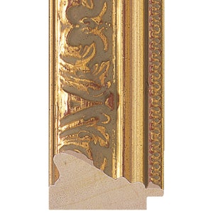 May include: A gold picture frame with a decorative, ornate design. The frame has a raised edge and a smooth, flat surface.