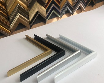 May include: Four picture frame molding samples in gold, black, silver, and white. The molding is made of metal and has a simple, modern design.