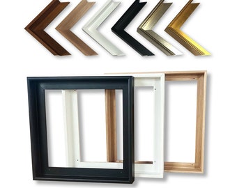 May include: Three different wood canvas stretcher bars in black, white, and natural wood. The bars are stacked on top of each other. The top of the bars are visible in the image. The bars are used to create a canvas frame for painting.