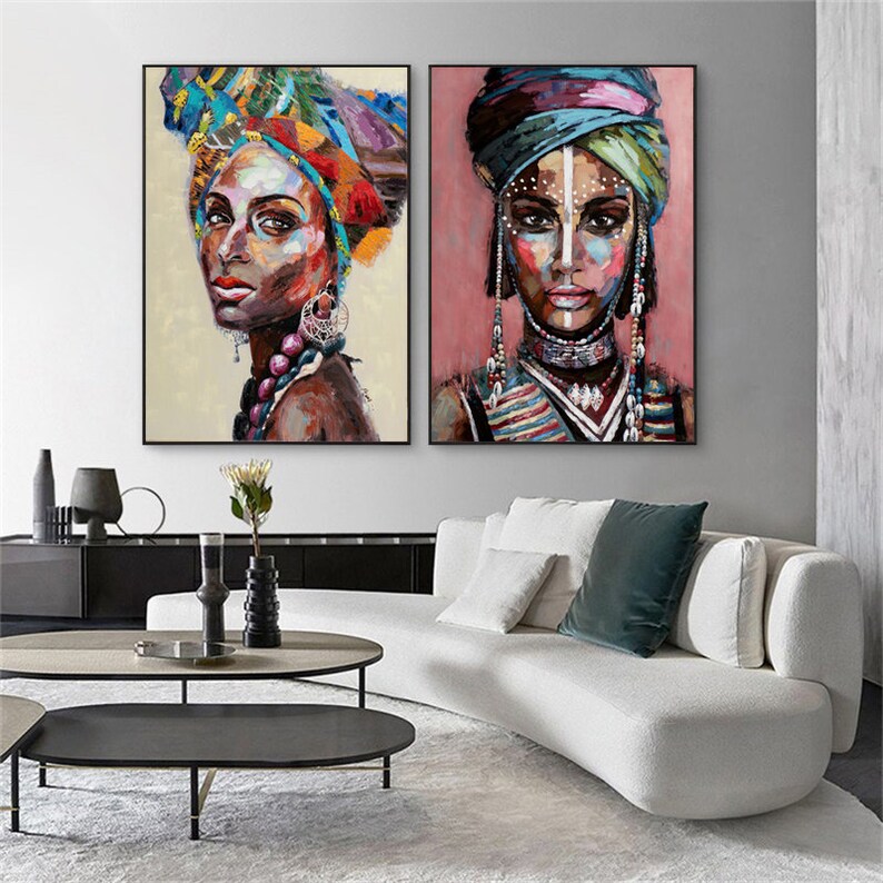 May include: Two colorful paintings of women with bold makeup and elaborate headwear. The paintings are in a modern style and feature vibrant colors.