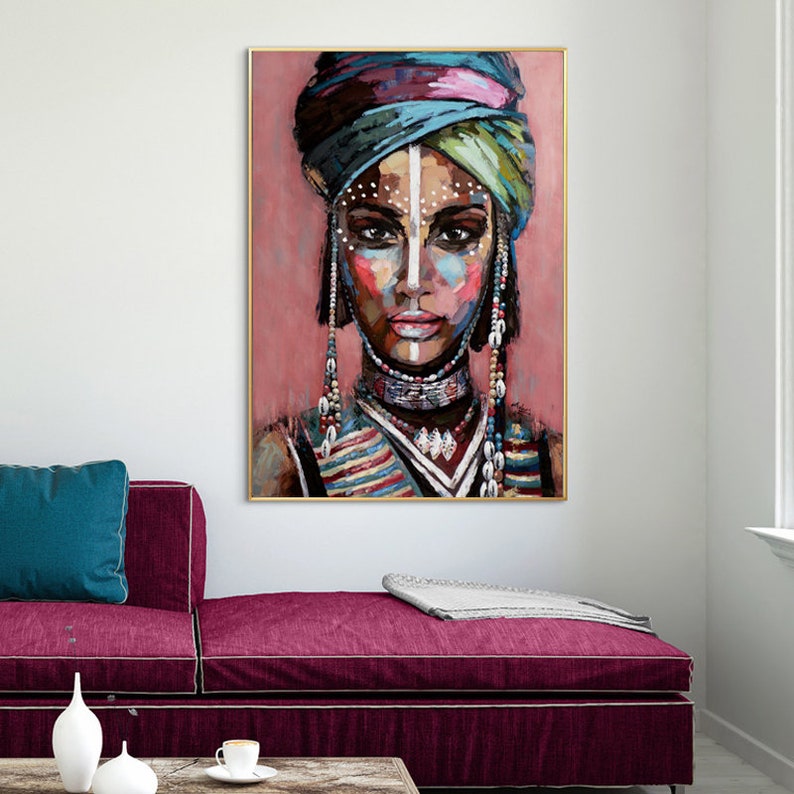May include: A painting of a woman with colorful makeup and a blue and purple head wrap. She is wearing a beaded necklace and a striped shirt.