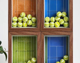 May include: Four rectangular shadow box frames with dark wood grain finish, each containing a tennis court graphic background in orange, blue, green, or dark blue, filled with multiple yellow tennis balls behind a clear protective panel.