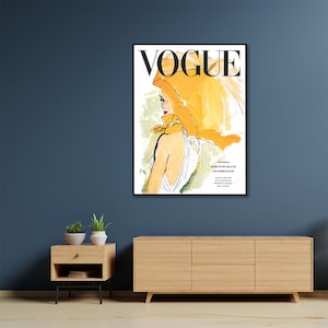 May include: A vintage Vogue magazine cover featuring a woman wearing a yellow headscarf and a white dress. The cover text reads "Vogue" in black letters.