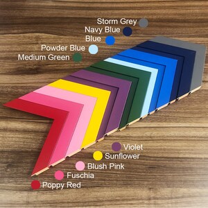 May include: A variety of picture frame molding samples in different colors, including poppy red, fuchsia, blush pink, sunflower yellow, violet, medium green, powder blue, blue, navy blue, and storm grey.