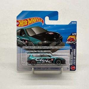 May include: A teal and black Honda Civic Custom die-cast toy car in its original blue and white Hot Wheels blister packaging. The car features the word Civic in white script on the side, the number 59 in a red circle, and black wheels.