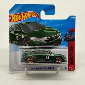 May include: A dark green 2018 Honda Civic Type R die-cast toy car by Hot Wheels. The vehicle features gold-coloured wheels and a black circular logo with the letters Js on the side. It is packaged in a blue and white blister card with the text NIGHTSPEED.